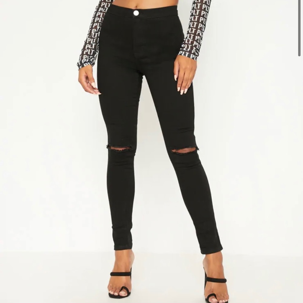 Black skinny jeans with slits at knees
